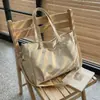 Bolsa de Lona para o Dia a Dia 2026 Novo Estilo Coreano Ins Versátil e Estilosa Bolsa Tote para Mulheres do Escritório