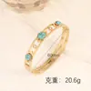 Nova Joia Europeia e Americana de Aço Titânio, Pulseira Olho com Gotejamento de Óleo, Pulseira Oca de Aço Inoxidável Estilo Corte com Turquesa Incrustada