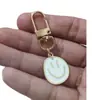 Llavero de cara sonriente de color aleación con goteo transfronterizo de comercio electrónico, accesorios de colgante para bolso con expresión irregular chapado en oro