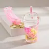 Famoso de Redes Sociales botella de arena movediza taza de té con leche llavero colgante creativo colgante de botella de arena movediza con aceite colgante pequeño para mochila escolar de estudiante
