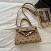 Bolso Kelly nuevo y versátil para mujer 2026, lujo ligero, moderno, de nicho, cuadrado pequeño, para ir al trabajo, bolso de mano de lunares