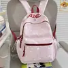 Nuevo modelo 2026 mochila casual estampada estilo ins para estudiantes de secundaria y primaria, mochila ligera de gran capacidad para ir a la escuela para niñas