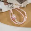 Nuevo colgante de teléfono de doble cadena con un toque de alta gama, cuentas luminosas de flor de cerezo, correa de muñeca para teléfono, charm para bolso, pequeño regalo para mujeres