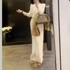 Comercio exterior transfronterizo otoño e invierno nueva moda conjunto casual de punto para mujer, conjunto de dos piezas de falda y suéter adelgazante de color liso