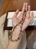 Collar de Gato Maillard Partícula Pequeña Ojo de Tigre Moca Dorado Marrón Concha Cadena de Lana Otoño e Invierno para Mujer Facetado Ojo de Tigre