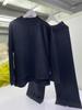 Ropa europea otoño e invierno 2023 Nuevo conjunto de dos piezas de suéter holgado de color sólido con abertura y pantalones de punto de pierna ancha traje de moda