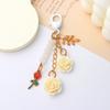 Llavero con borla de flor de camelia de resina estilo Ins, colgante de flor de hoja, colgante decorativo para bolsa de auriculares de niña