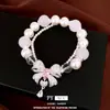 Pulsera con colgante de lazo de circonita con perlas de doble capa, sensación de lujo ligero y alta gama, accesorio de mano elegante y versátil