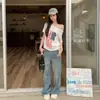 Camiseta Casual Feminina de Manga Curta, Estampa de Bandeira Americana, Modelo Soltinho, Ombro a Ombro, Versátil, Verão 2026