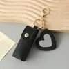 Mini llavero de lipstick portátil, bolsa redonda de cuero con espejo de maquillaje, accesorio para niñas, colgante de bolsa de espejo de maquillaje portátil