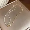 Collar de perlas de doble capa con borla estilo francés, moda de nicho de alta gama, cadena simple para la clavícula, exquisito y versátil, accesorio elegante