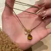 Nova Corrente de Suéter com Pingente de Cabacinha Olho de Tigre Tecida Preto e Dourado Tendência Outono/Inverno com Novo Estilo Chinês e Sensação Exquisita de Alto Padrão