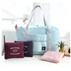 Nueva bolsa de almacenamiento de rendimiento de gran capacidad bolsa de almacenamiento para el hombro bolsa plegable portátil bolsa para avión bolsa de regalo al por mayor en stock