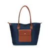 Bolsas Femininas de Comércio Exterior 2026 Verão Novo Estilo Bolsa de Mão Feminina de Nylon Bolsa Tote de Grande Capacidade para Aula e Trabalho Bolsa de Ombro