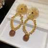 Pendientes de borla con carcasa de madera marrón transfronterizos europeos y americanos, pendientes de estilo vintage Maillard, pendientes de mujer de lujo ligero de alta gama