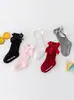 Nuevos calcetines largos de rayas de color sólido para niños y niñas, algodón-poliéster antideslizantes con parte superior de burbuja, calcetines de media pantorrilla con lazo para bebé al por mayor