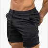 Amazon verano pantalones cortos de secado rápido para hombre color liso deportes fitness pantalones de cinco puntos pantalones de playa fabricantes venta al por mayor