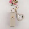 Bolsa Popular Portátil Transfronteriza para Labiales Llavero con Colgante de Cuero Accesorio Bolsa de Almacenamiento para Labiales Mini Espejo en Forma de Corazón