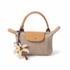 Mini bolso de mano tejido con paja transfronterizo tipo dumpling, bolso de mano retro con tapa abatible, nuevo estilo 2026 bolso tejido para mujer, personalizable para vacaciones