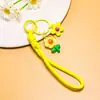 Venta al por mayor de pequeños, frescos, estilo coreano, flor de girasol acrílica, flor de goma suave, cordón trenzado hecho a mano, accesorios para cordón de teléfono
