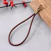 Estilo Retro Nuevo Cadena de Mano de Doble Botón de Piel de Vaca Colgante de Bolso Reemplazable Colgante de Muñeca de Teléfono Móvil Antirrobo de Gama Alta