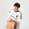 Camiseta de manga corta resistente con estampado de letras de tres rayas, estilo callejero americano para hombre, top de marca de moda de verano para pareja