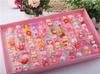 10 Caja en forma de corazón Regalo de cumpleaños 1 de junio Forma de corazón Niñas Bebé Juguete Anillo Dibujo animado Anillo abierto Venta al por mayor