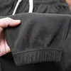 Pantalones deportivos de punto gofre para hombre, nuevo estilo de verano, corte holgado, pantalones casuales cropped, pantalones jogger de pierna ancha a la moda estilo coreano, finos y de tiro bajo