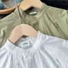 2026 Nova Coleção de Outono Roupas Infantis: Camisa Manga Longa Branca Pura Solta Versátil Estilo Japonês Gola Alta Infantil Nantong Venda por Atacado