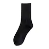 Calcetines de algodón de Xinjiang para hombres y mujeres con las mismas temporadas de otoño e invierno absorbentes de sudor desodorantes calcetines cortos calcetines de tubo medio deportivos de baloncesto otoño e invierno