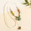 Collar con colgante de campana de mariposa de cerámica de estilo étnico retro para mujer, diseño nuevo y moderno, cadena larga para suéter, accesorios