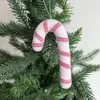 Decoraciones navideñas transfronterizas: bastones de caramelo rojos y blancos, arreglos de escenas en escaparates de centros comerciales, dulces, ramas de árbol de Navidad y artículos decorativos