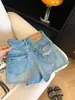Shorts jeans jeans azul estilo retrô americano A-line feminino verão 2026 novo cintura alta hot pants pequeno rasgado