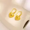 Tienda de oro con pendientes huecos de color dorado en forma de corazón y trébol de cuatro hojas, pendientes de color alto dorado claro para novia