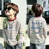 Camiseta de algodón puro a rayas de manga larga para niño, modelo nuevo 2026, camiseta base con estampado de dibujos animados para niños para ropa exterior de primavera y otoño