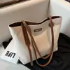 Bolsa feminina casual de grande capacidade 2025 primavera/verão nova bolsa versátil de lona bolsa de ombro para o dia a dia bolsa tote simples