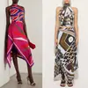 Comercio exterior transfronterizo verano nuevo conjunto de dos piezas con estampado estilo europeo y americano, cuello halter, falda irregular, estilo vacacional para mujer