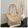 Bolsa casual de ombro popular deste ano, bolsa tote de grande capacidade para mulheres, nicho, para o trabalho, leve, versátil, bolsa transversal