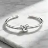 Pulseira de aço titânio aberta com nó tricolor, pulseira de nó concêntrico que não desbota, acessório de moda feminino transfronteiriço atacado