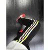 Calça Colorida com Três Listras Masculina Retro Americana Flare Calça de Moletom Esportiva Tendência High Street Reta Casual