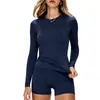 Conjunto de yoga de nailon en stock para mujer, corte ajustado, manga larga, conjunto deportivo de dos piezas, ropa de fitness negra, realza glúteos, control de abdomen, secado rápido