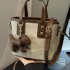 Bolsos de nicho texturizados de alta calidad 2024 nuevos bolsos para mujer versátiles bandoleras retro de hombro bolsos cubo portátiles de moda