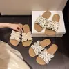 Sandalias planas cómodas estilo hada para mujer, nuevo modelo primavera-verano 2025, sandalias planas para uso exterior, combinan con faldas, dulces zapatos de playa