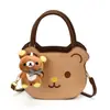 Bolsa de mão nova com formato de ursinho transfronteiriça feminina estilo coreano nicho para o dia a dia desenho animado mini infantil de ombro único transversal