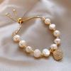 Pulsera elegante de ojo de gato Ins Moda de Corea del Sur Pulsera versátil de concha y perla natural Pulsera moderna ajustable para mujer
