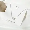Collar de amor sencillo de estilo japonés y coreano, cadena de clavícula con astas cruzadas, flor, perla y colgante de latido de corazón de celebridad cibernética.
