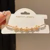 Pulsera de Trébol de la Suerte Hueca Electrochapada en Oro Real de 18K con Circonita, Pulsera Exquisita de Nicho de Lujo Ligero con un Toque de Alta Gama y Diseño Versátil