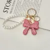 Chaveiro Laço Cheio de Diamantes Crystal Light Luxo Completo Sensação de Alto Padrão Pingente de Bolsa com Corrente de Pérola Tendência da Moda Pingente de Strass