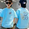 Camiseta de algodón puro de manga corta para niños, nuevo estilo de verano con estampado de letras de dibujos animados, top holgado de moda para bebé de media manga