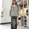 Sudadera con capucha gris de tres rayas estilo retro americano para mujer, nuevo modelo primavera y otoño 2026, chaqueta cárdigan estudiantil de corte holgado